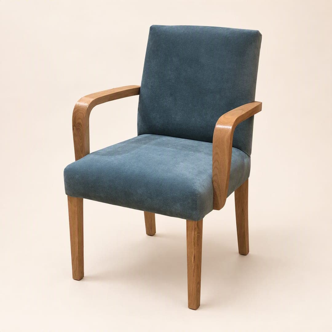 An armchair with timber arms and legs and a blue upholstered seat and back