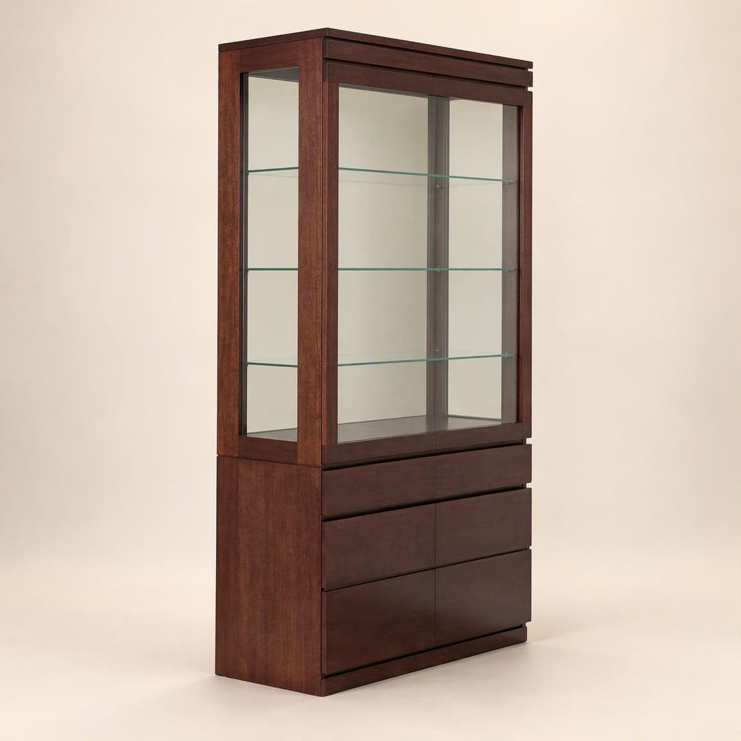 A tall dark-timber display cabinet with a glazed top over drawers